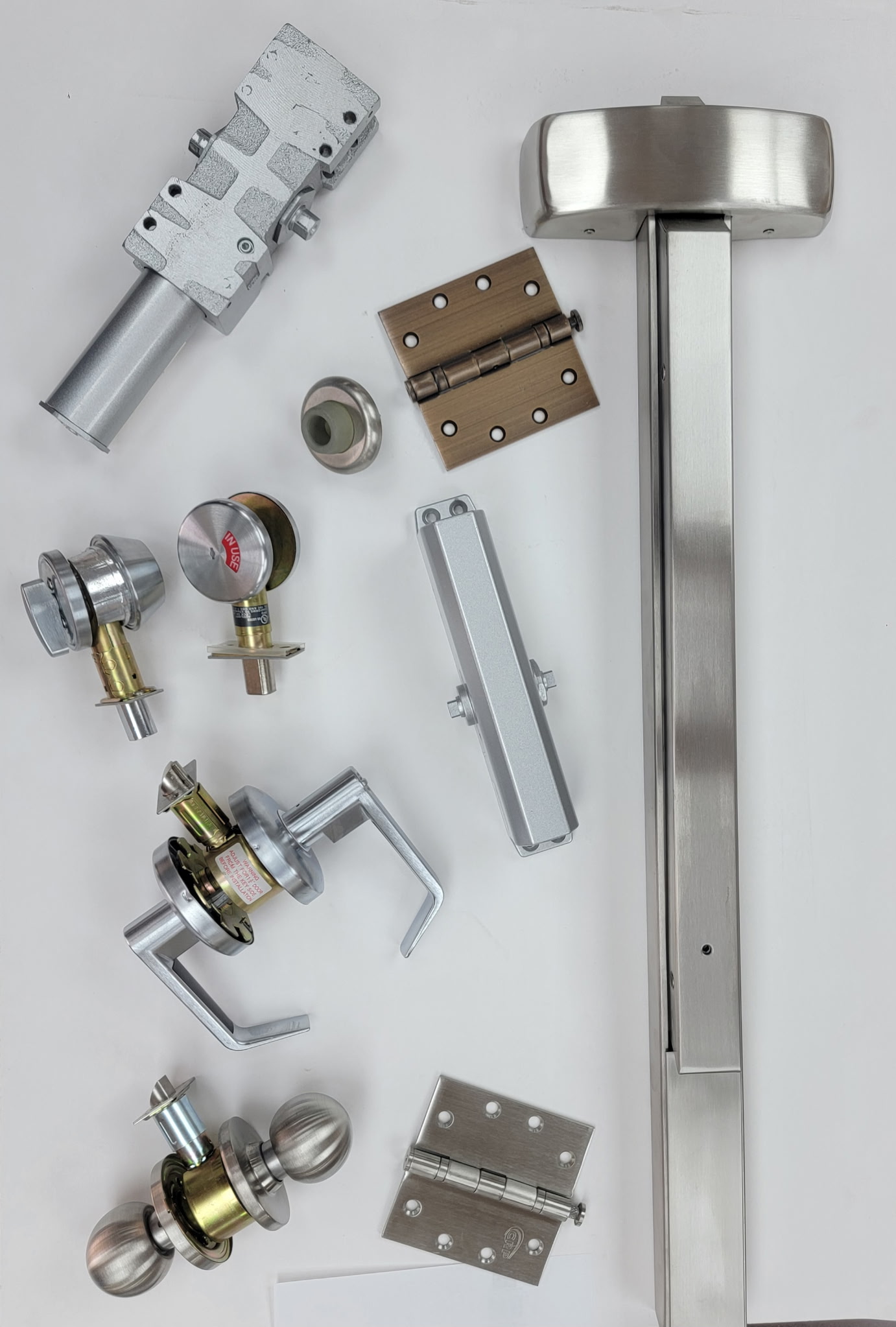Commercial door hardware — hinges, locksets, exit devices, and closers